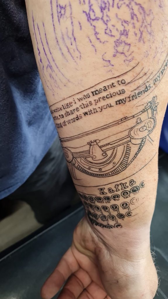 Images of my tattoo consisting of a typewriter and a nebula