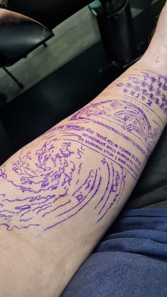 Images of my tattoo consisting of a typewriter and a nebula