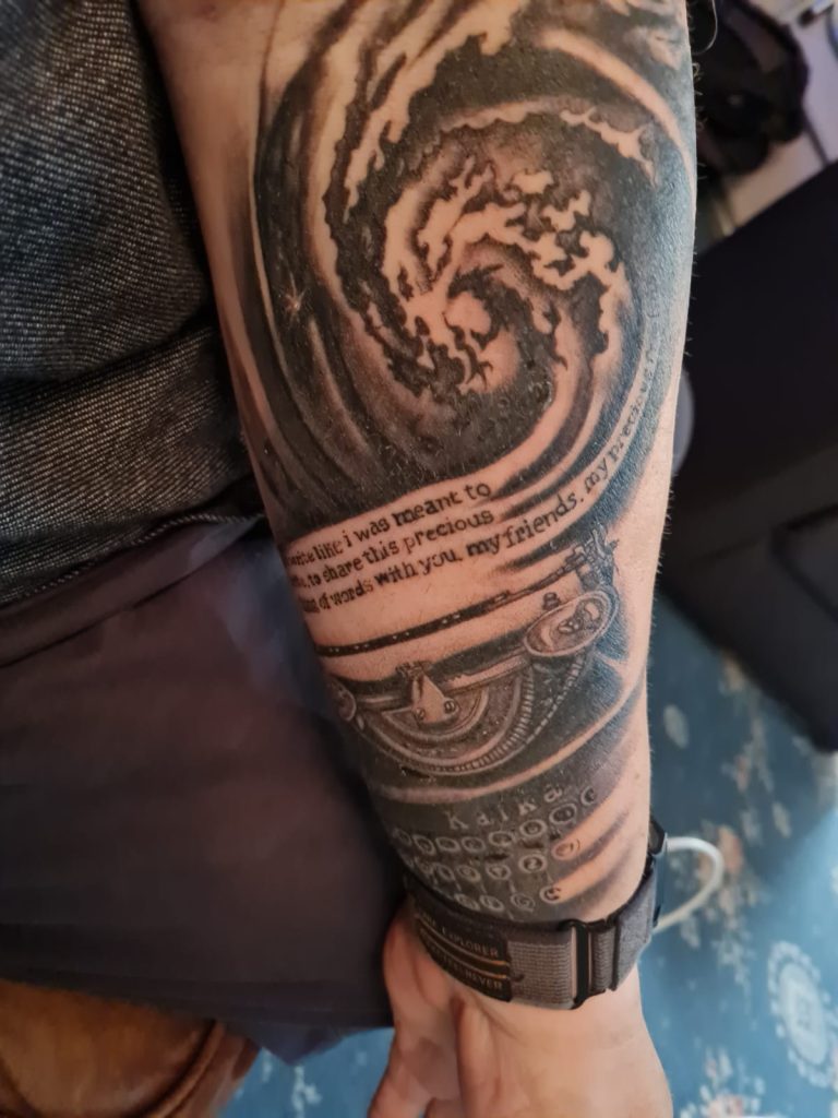 Images of my tattoo consisting of a typewriter and a nebula